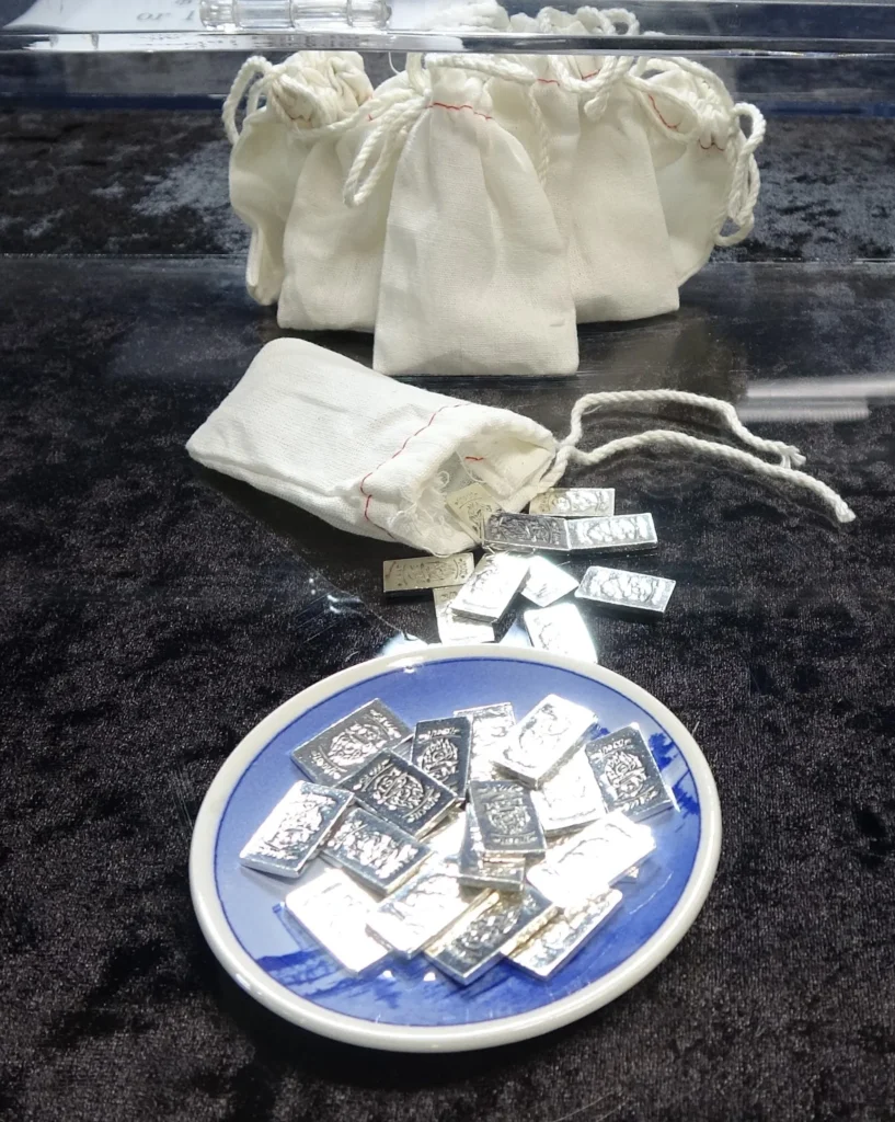 Small burlap bag with silver coins spilling out — Local Silver Mint silver barter bags for easy trading