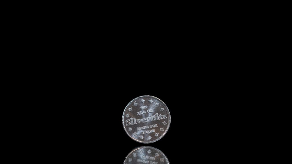 Two Silverstrike coins on black background