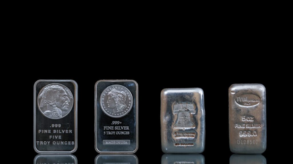 Four silver bullion bars and rounds